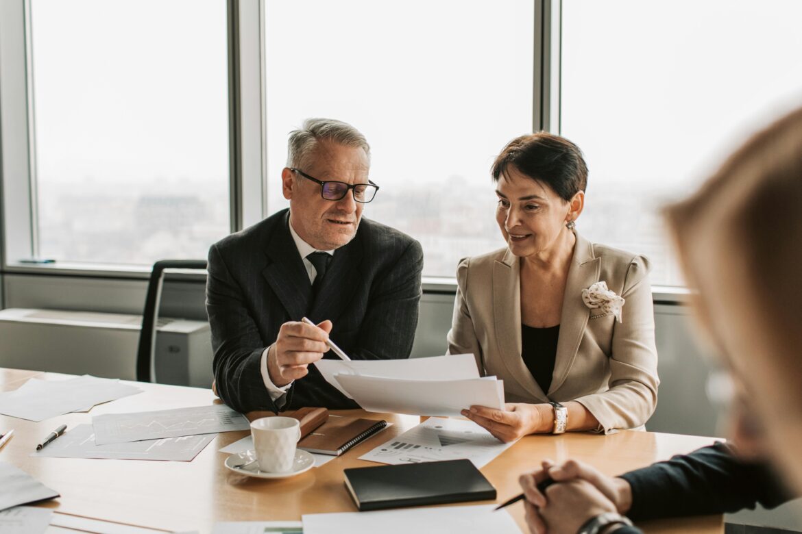 A man and a woman looking at papers