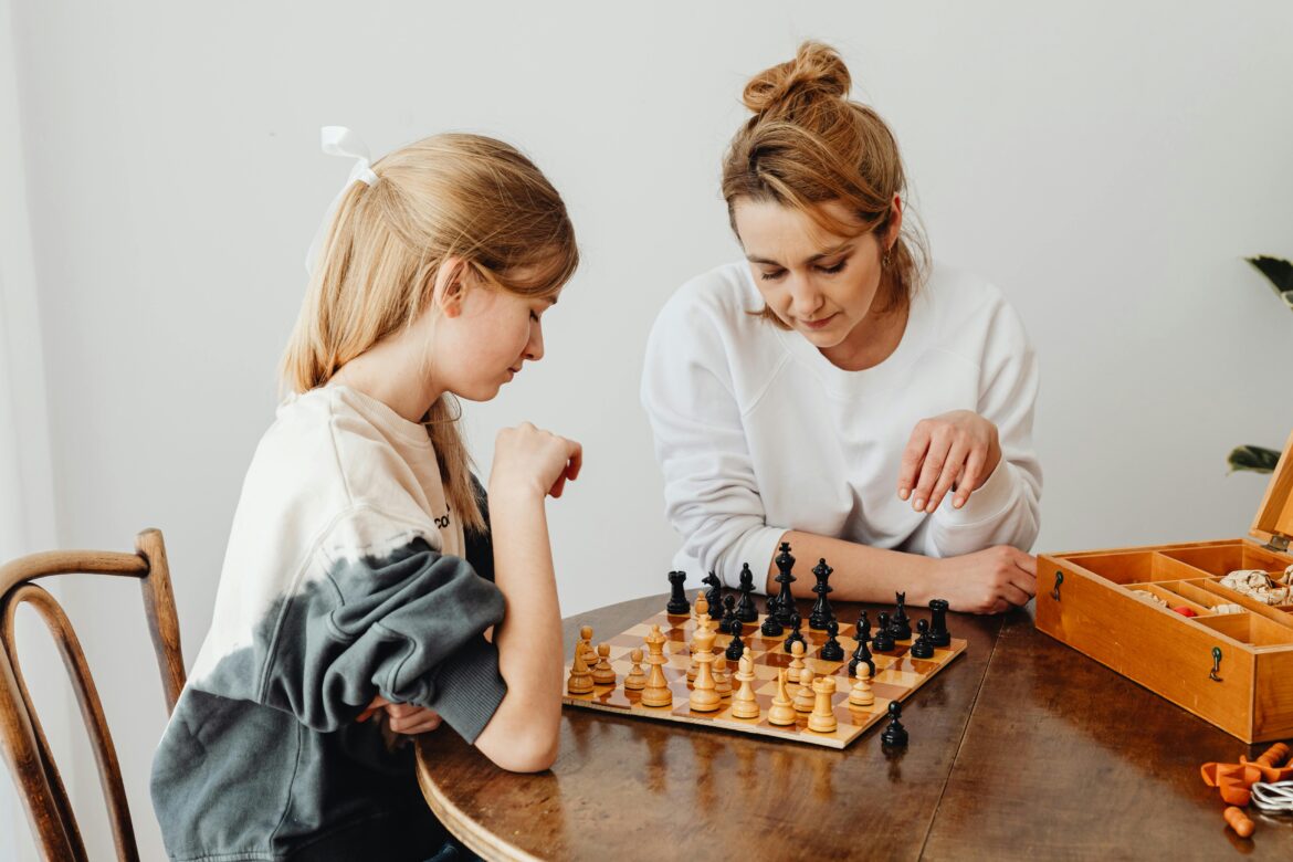 Woman and a girl playing chess
