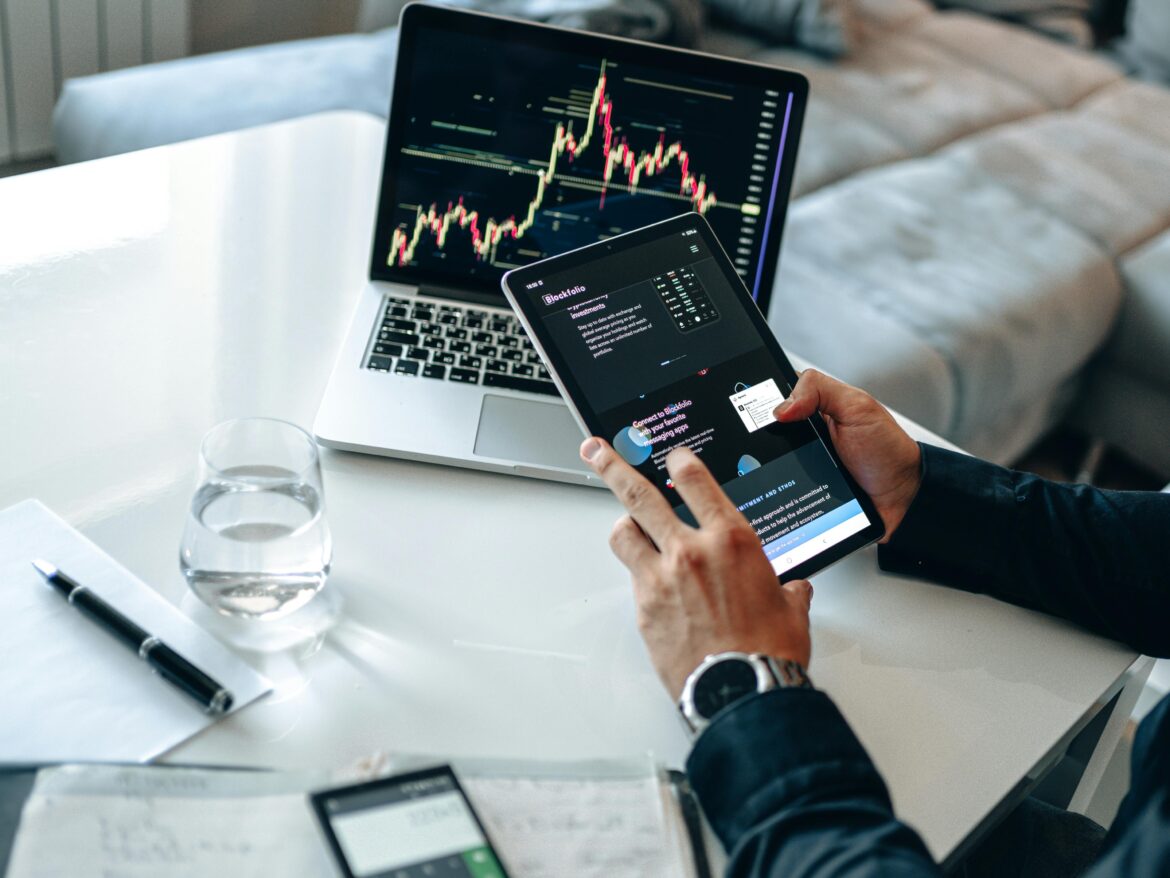 Person sitting holding a black android tablet computer