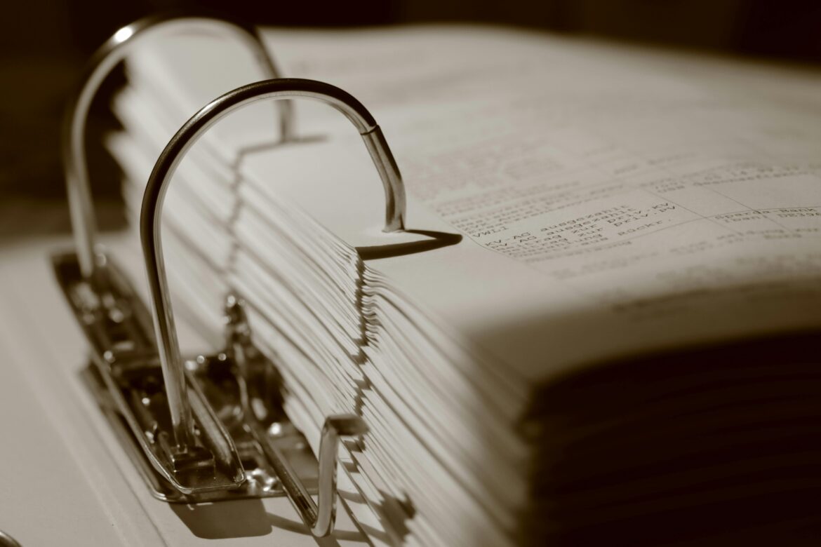Close up of a binder with documents in sepia tone