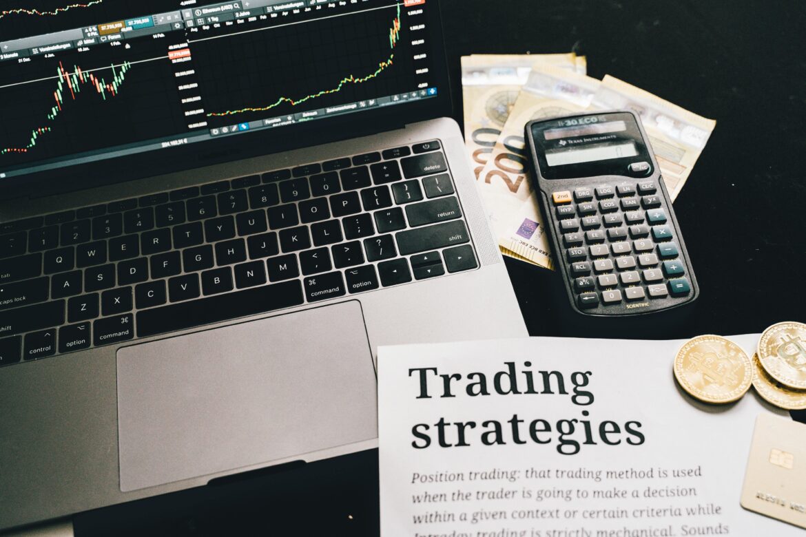 Research paper on trading strategies beside calculator and laptop