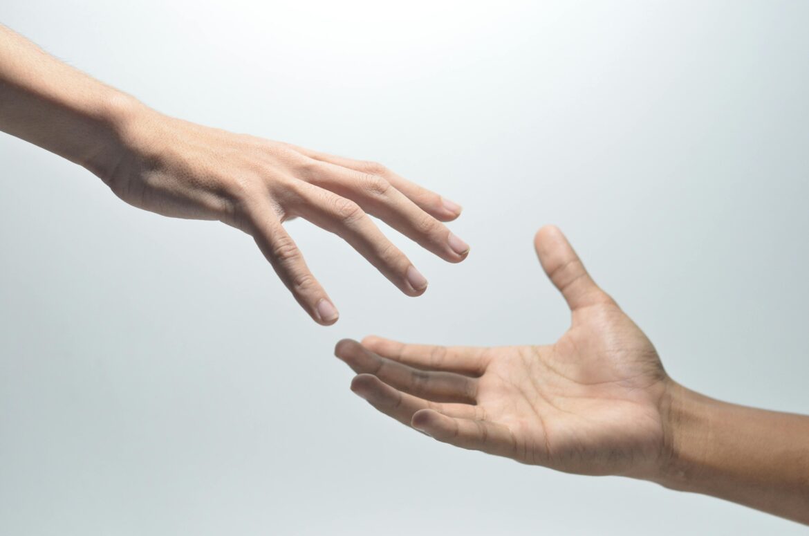 A couple reaching for each others hands