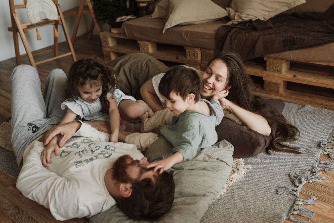 A family lying on the floor enjoying their bonding