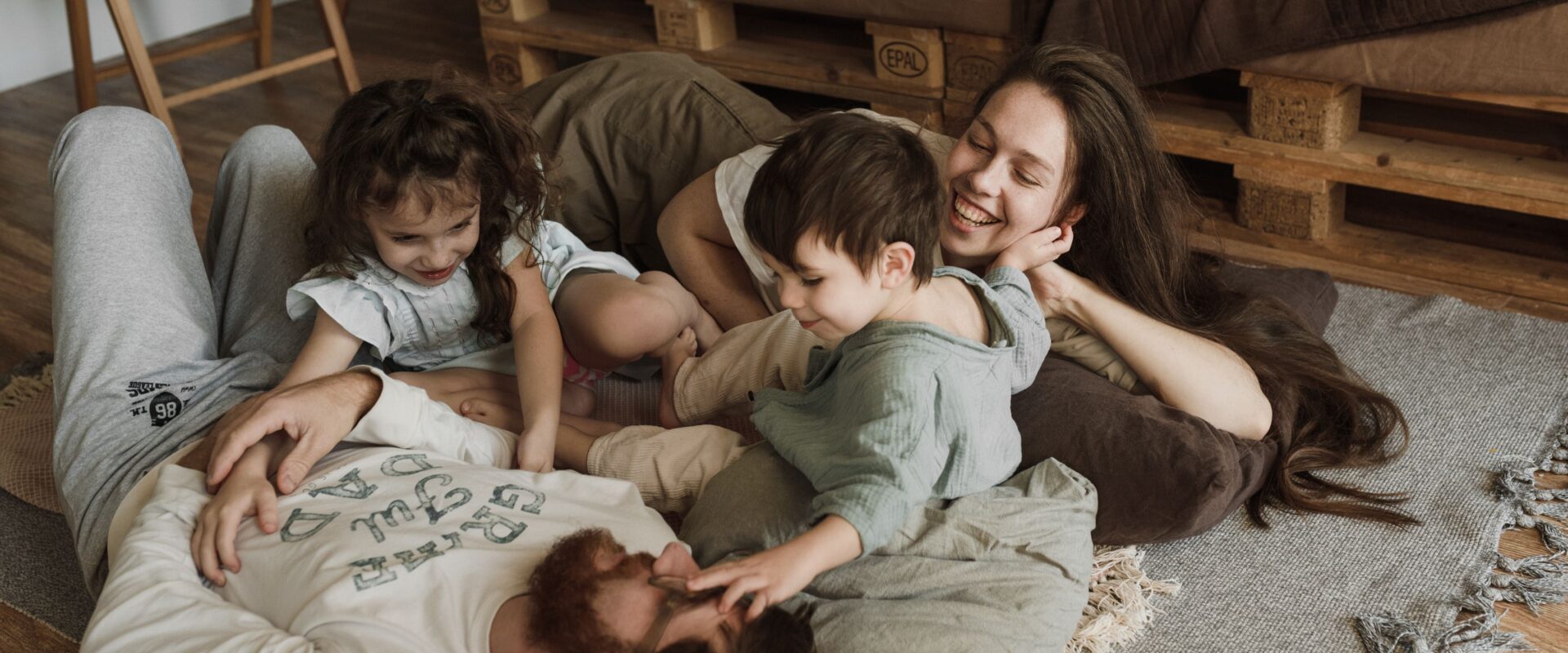 A family lying on the floor enjoying their bonding