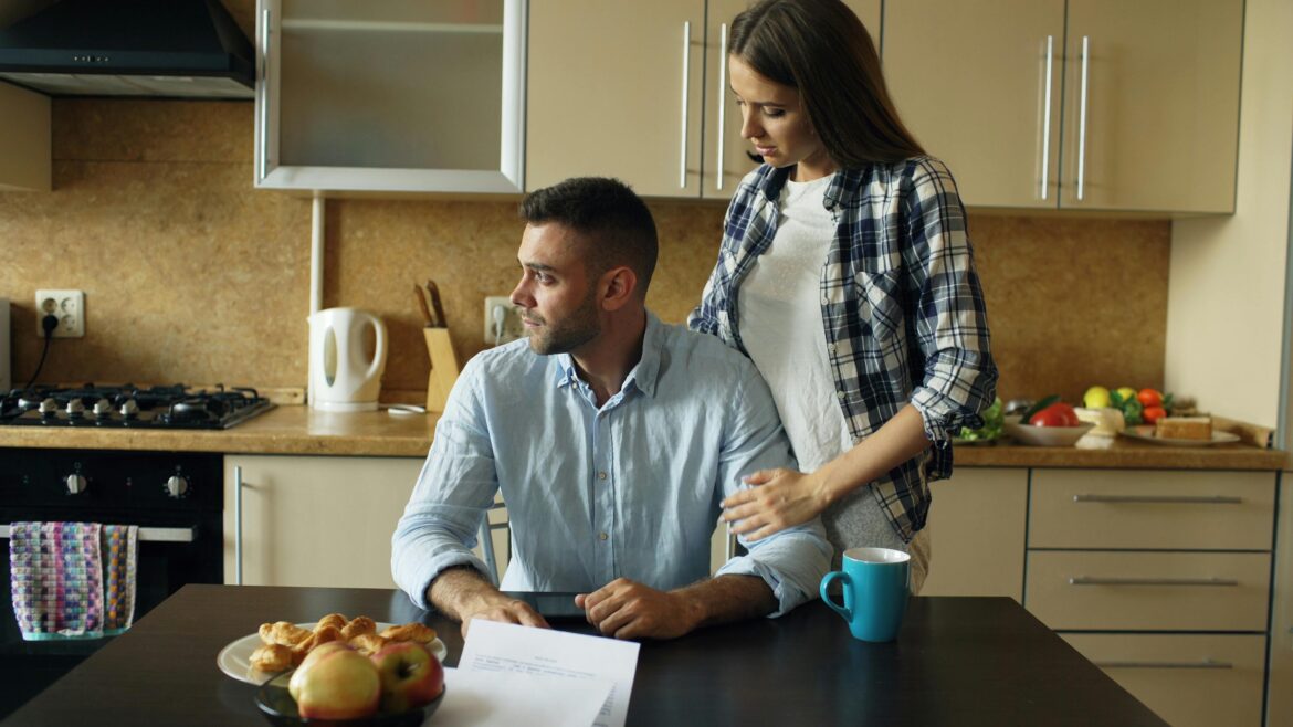 Couple discussing financial matters in kitchen