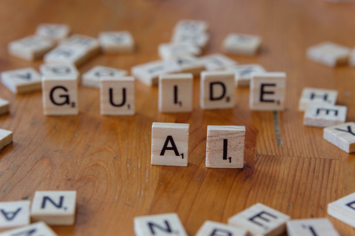 Guide and ai text blocks on wooden surface