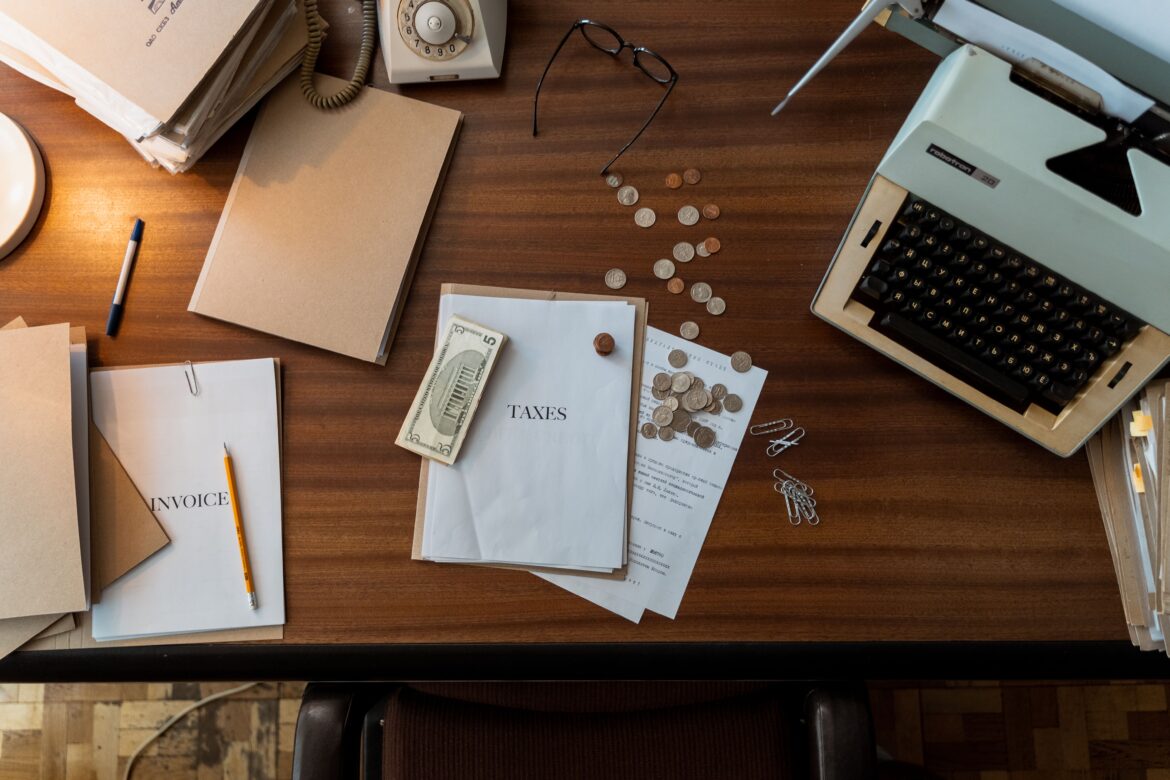 Dollar bills and coins top of documents