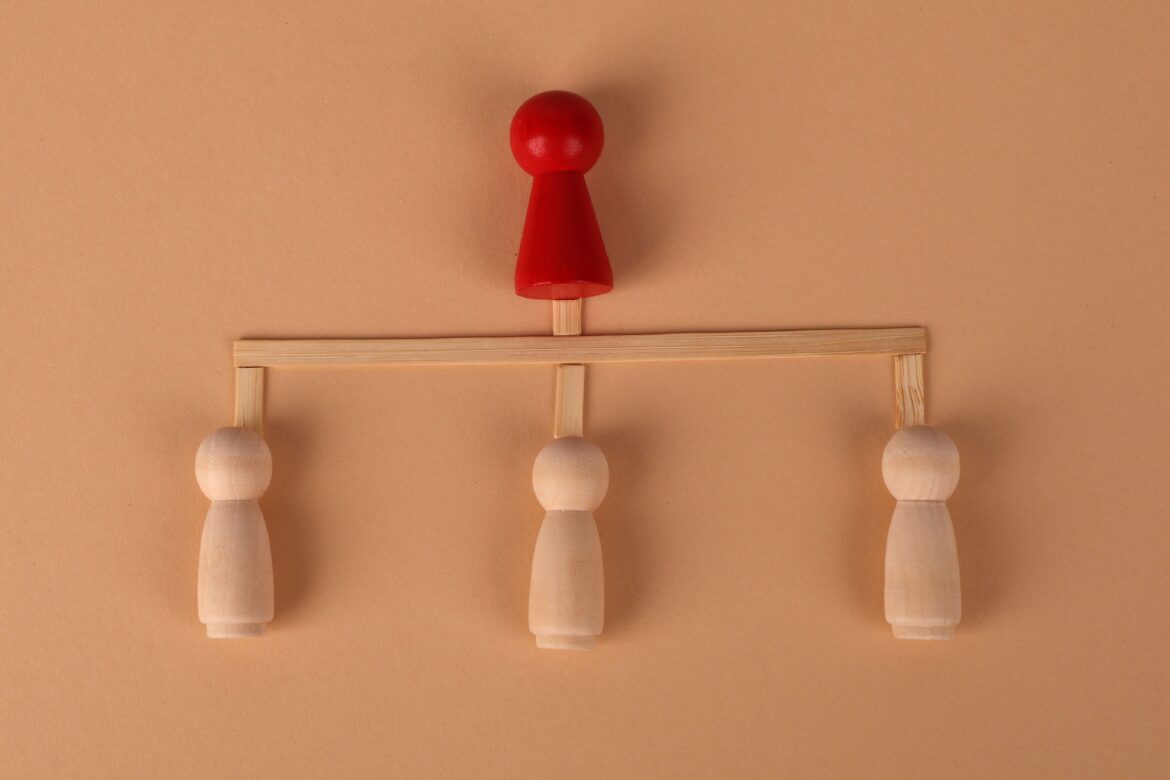 Abstract leadership concept with wooden figures