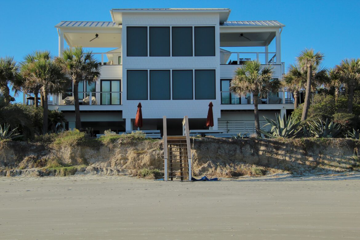 Modern beachfront house with palm trees
