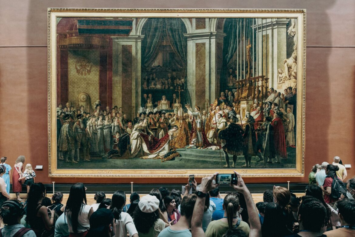People taking photos of the painting hanging on the wall