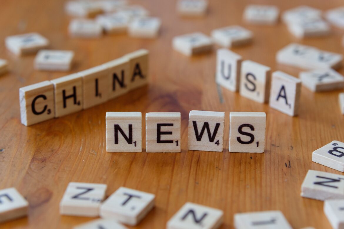 Scrabble tiles spelling news on wooden surface