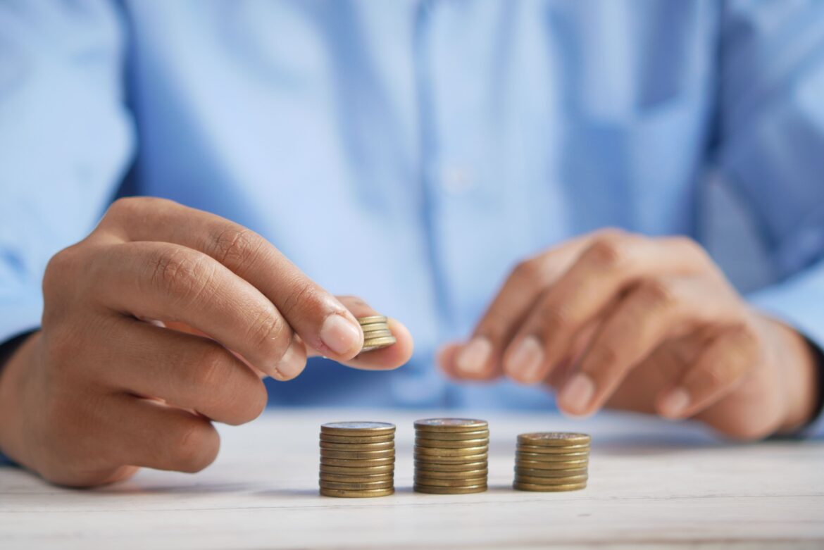 A close up shot of a person stacking coins