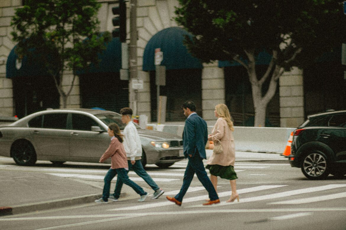 Family crossing urban intersection in the city