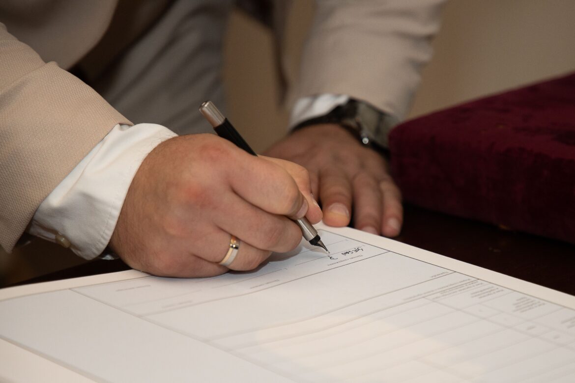 Groom signing document