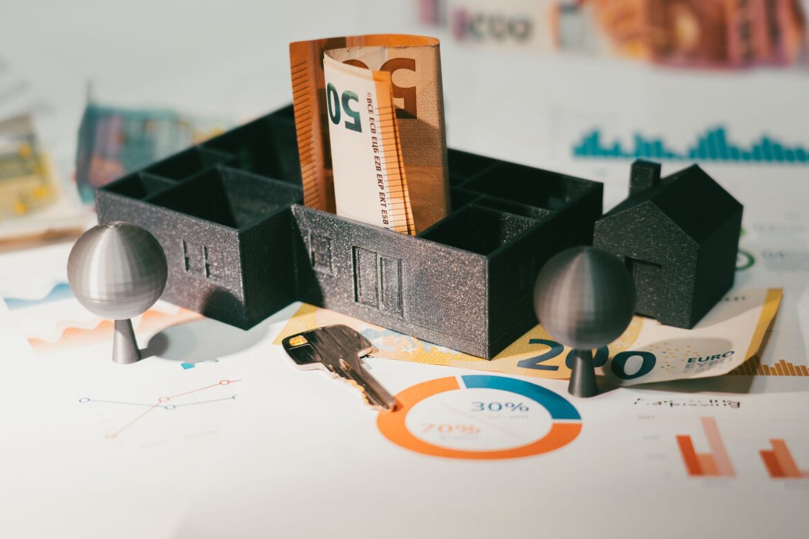 Real estate finance house model table money banknotes door key