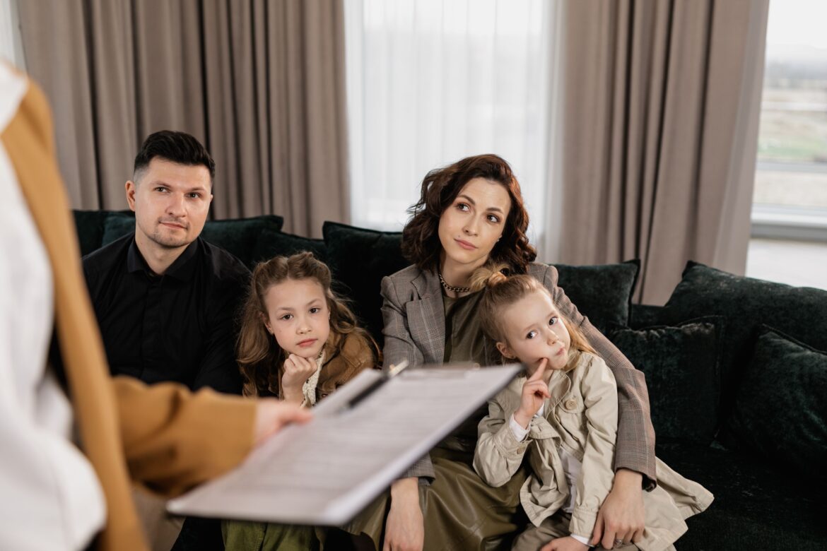 A family sitting on couch