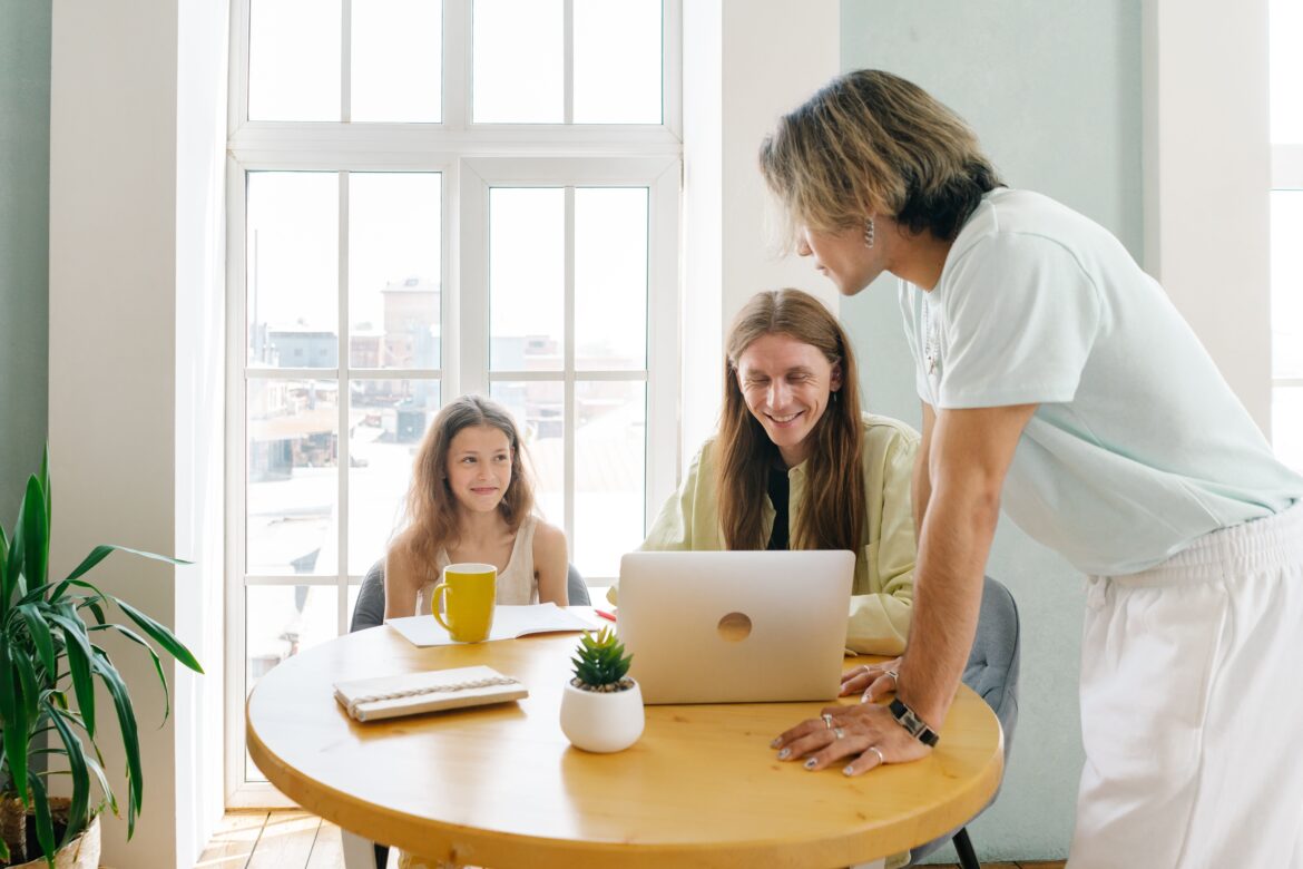 A happy family having a conversation while sitting near a wooden table