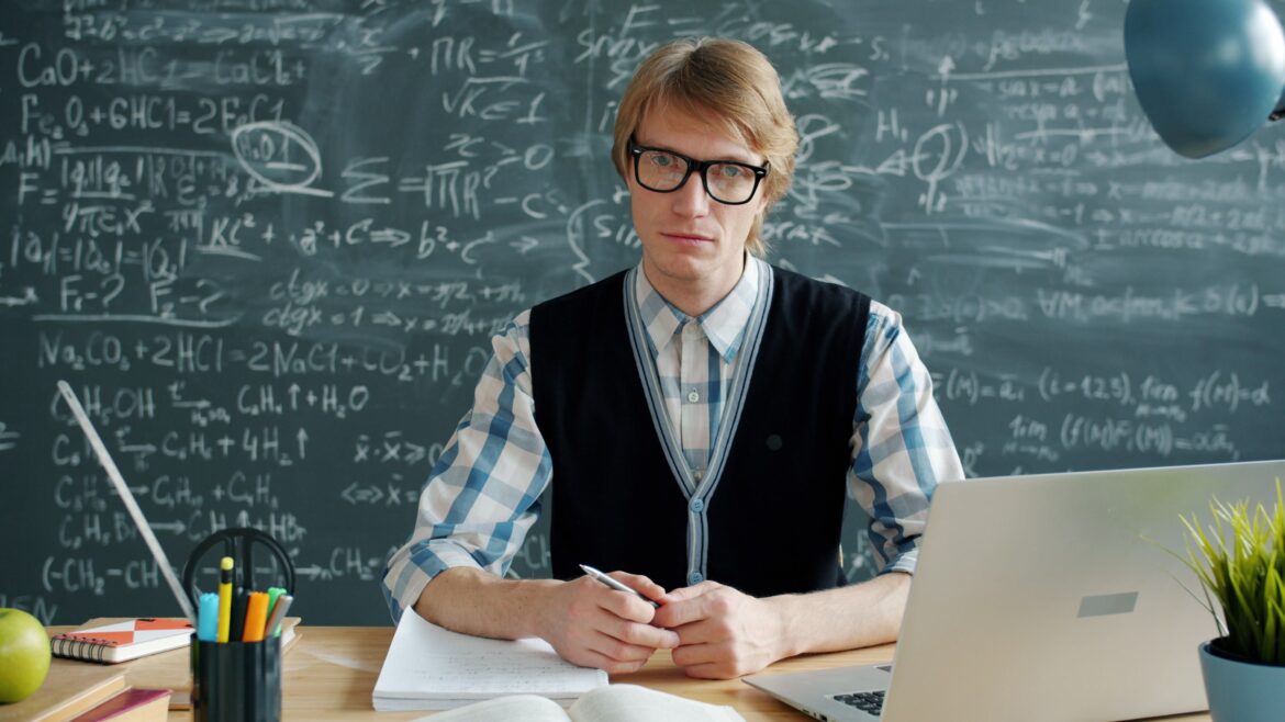Academic instructor in front of chalkboard with equations