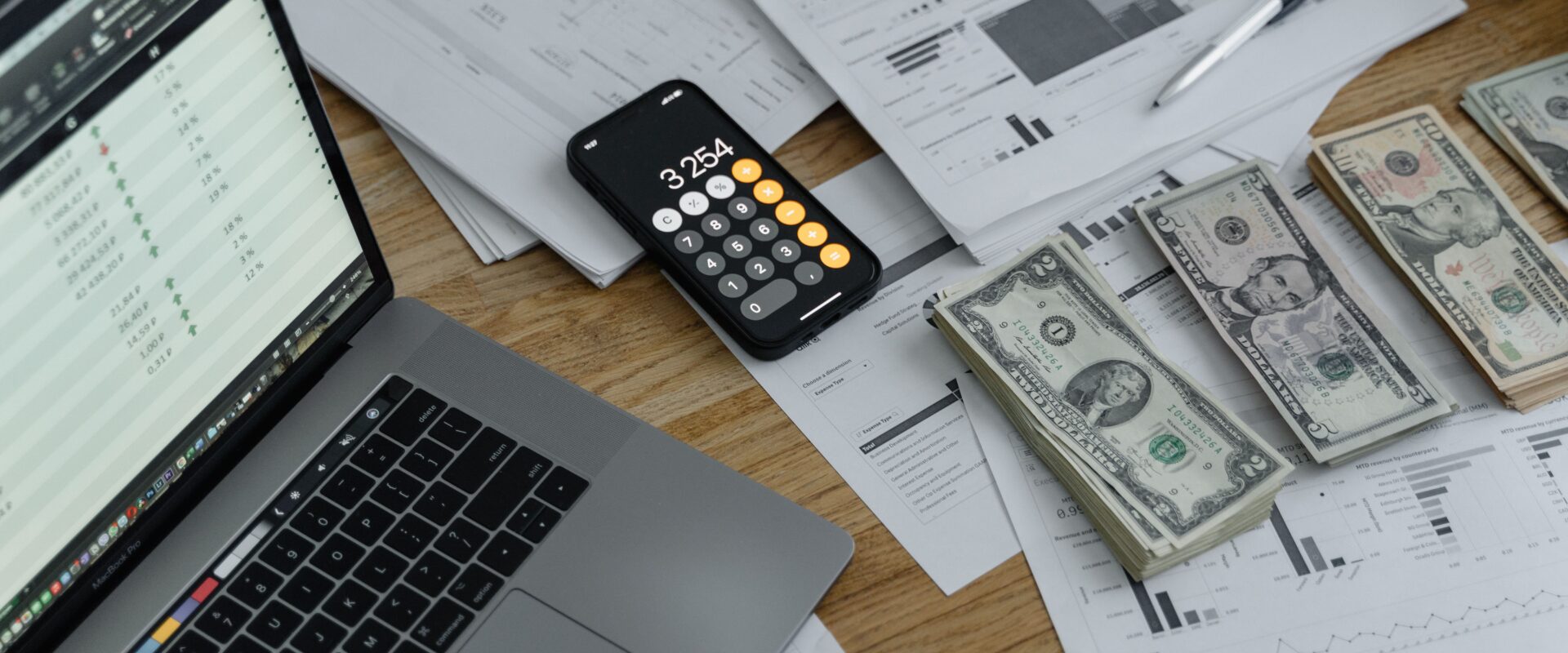 Banknotes and calculator on table