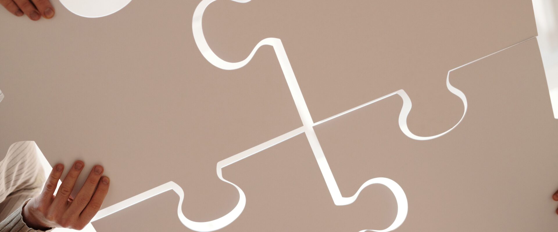 Close up photo of people holding puzzle pieces