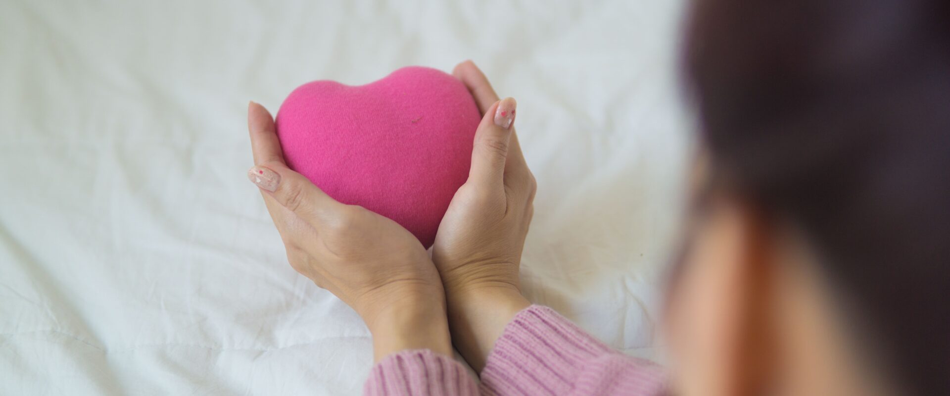 Crop woman with heart in hands