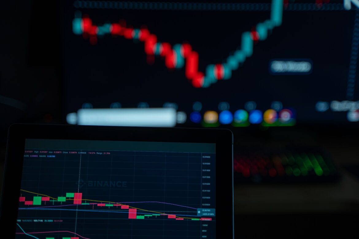 Cryptocurrency trading screens with market charts
