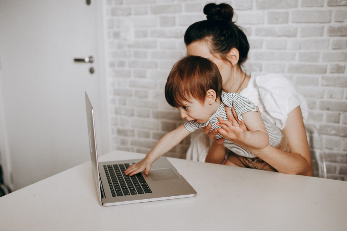 Mother and child using a laptop at home