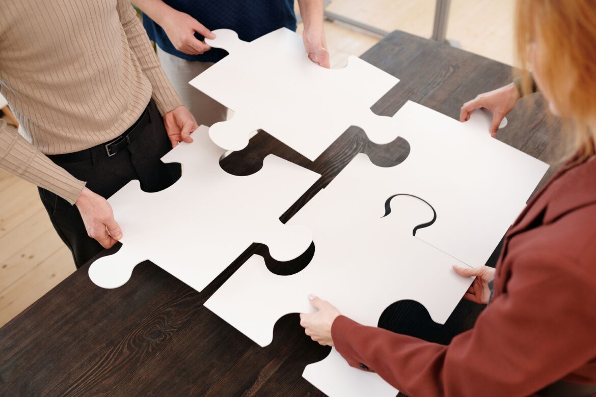 People holding puzzle pieces