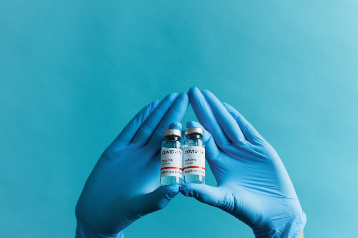 Person holding covid vaccines
