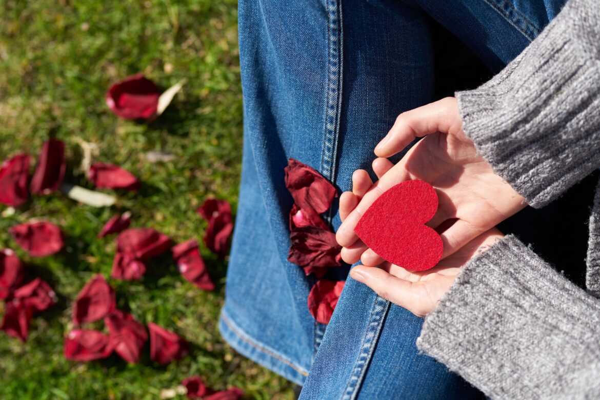 Person holding heart shaped cut out