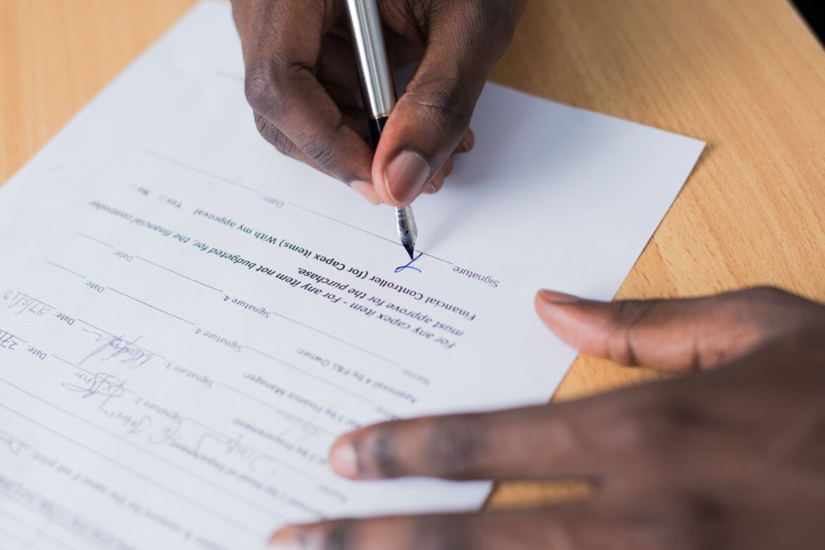Person signing paper