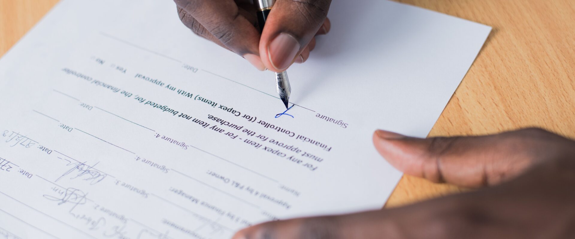 Person signing paper