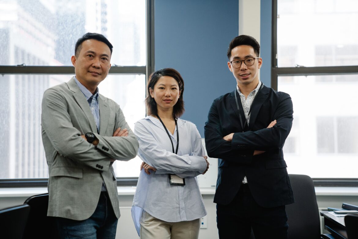 Photo of a group of employees with their arms crossed