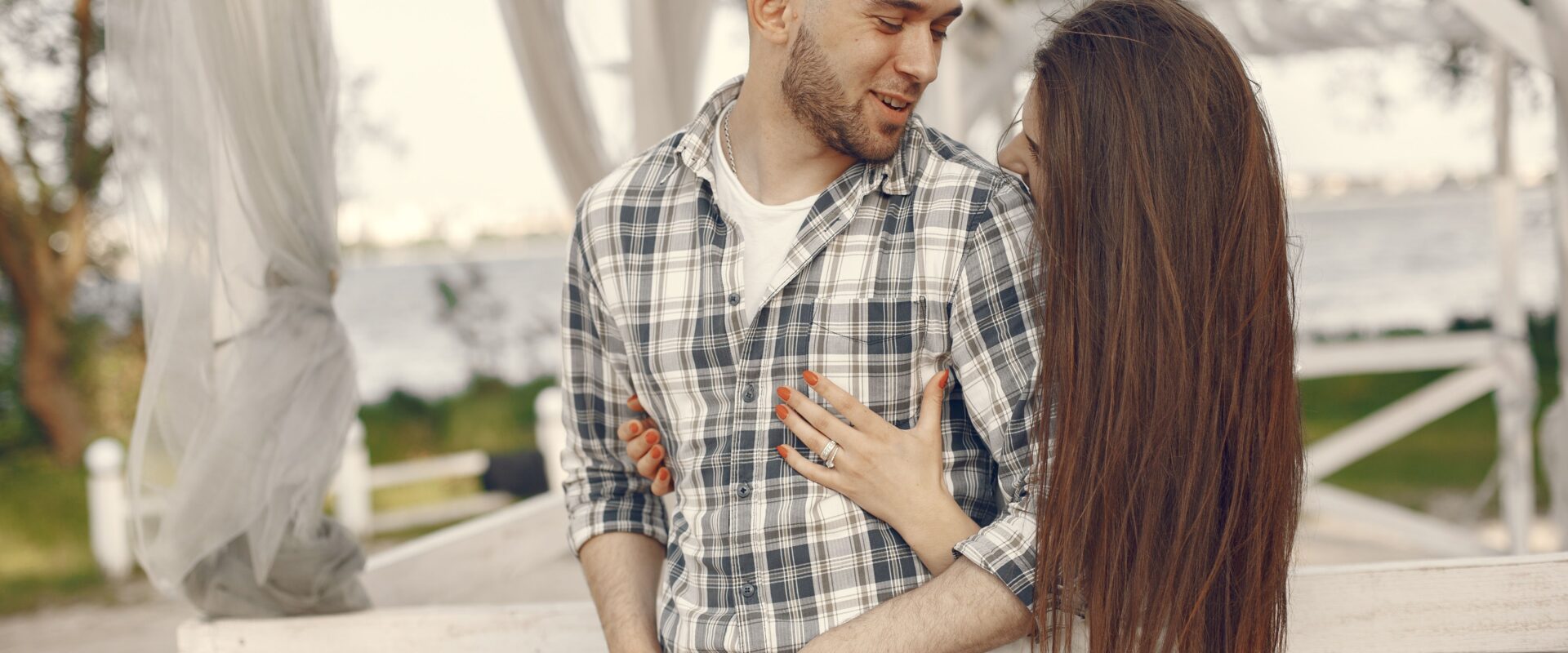 Shot of young woman hugging a man in a gazebo