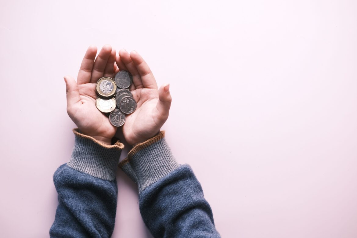 Silver coins on the person s palm
