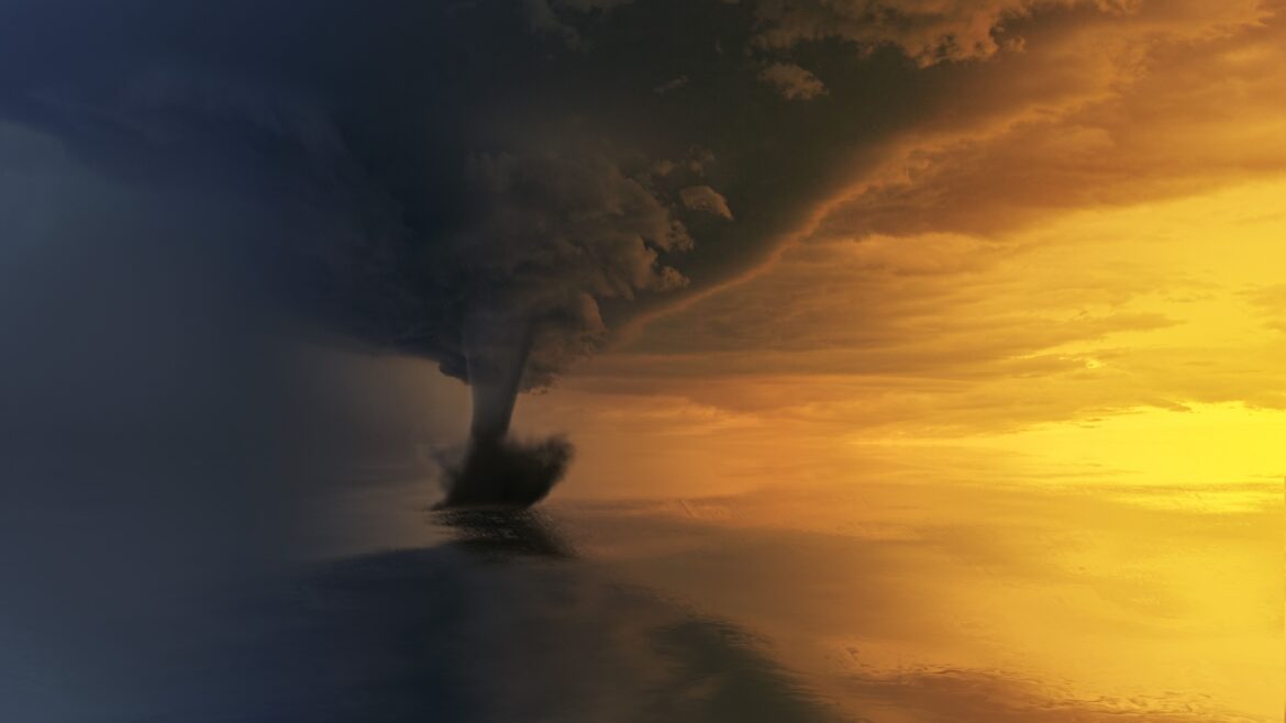 Tornado on body of water during golden hour