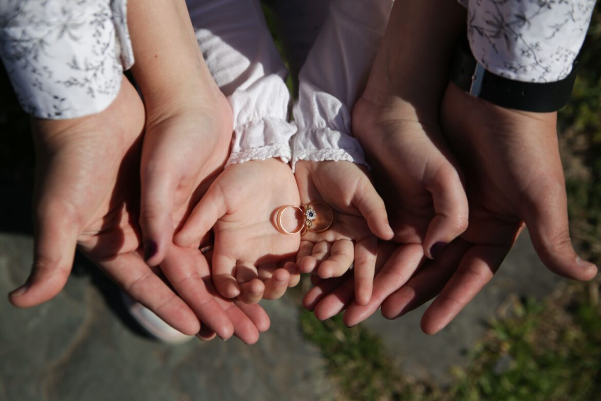 Woman in white dress holding her hands