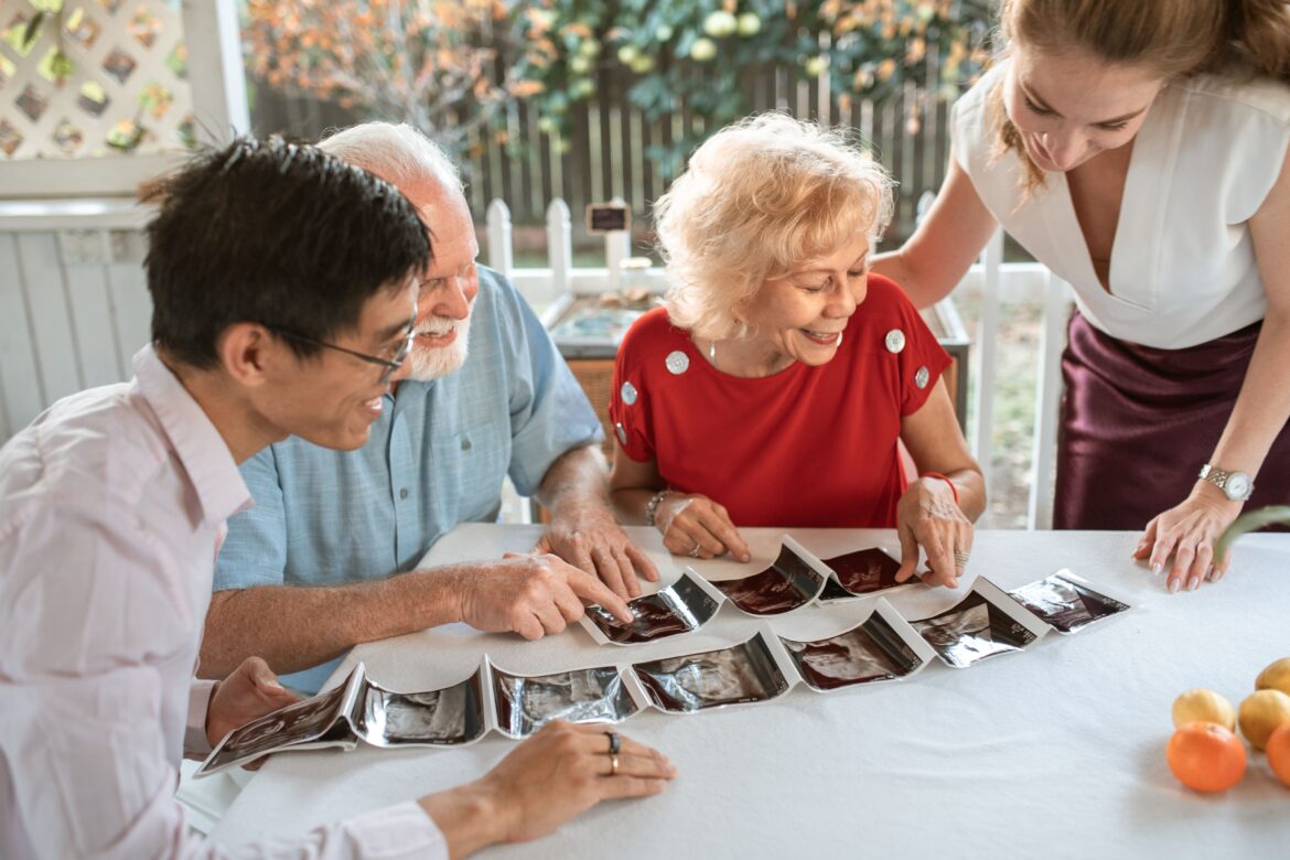 Woman showing pregnancy ultrasound results to relatives