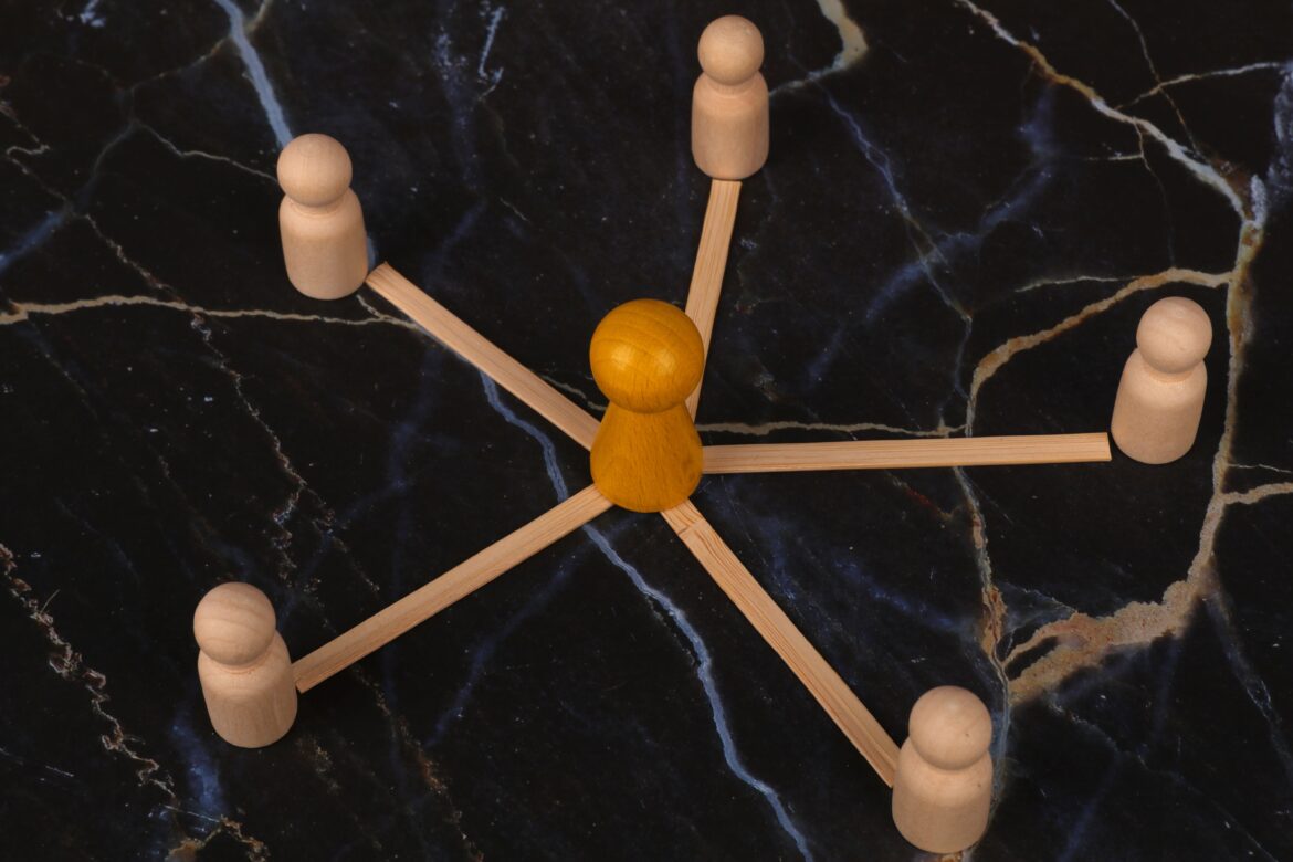 Wooden figures network concept on marble surface